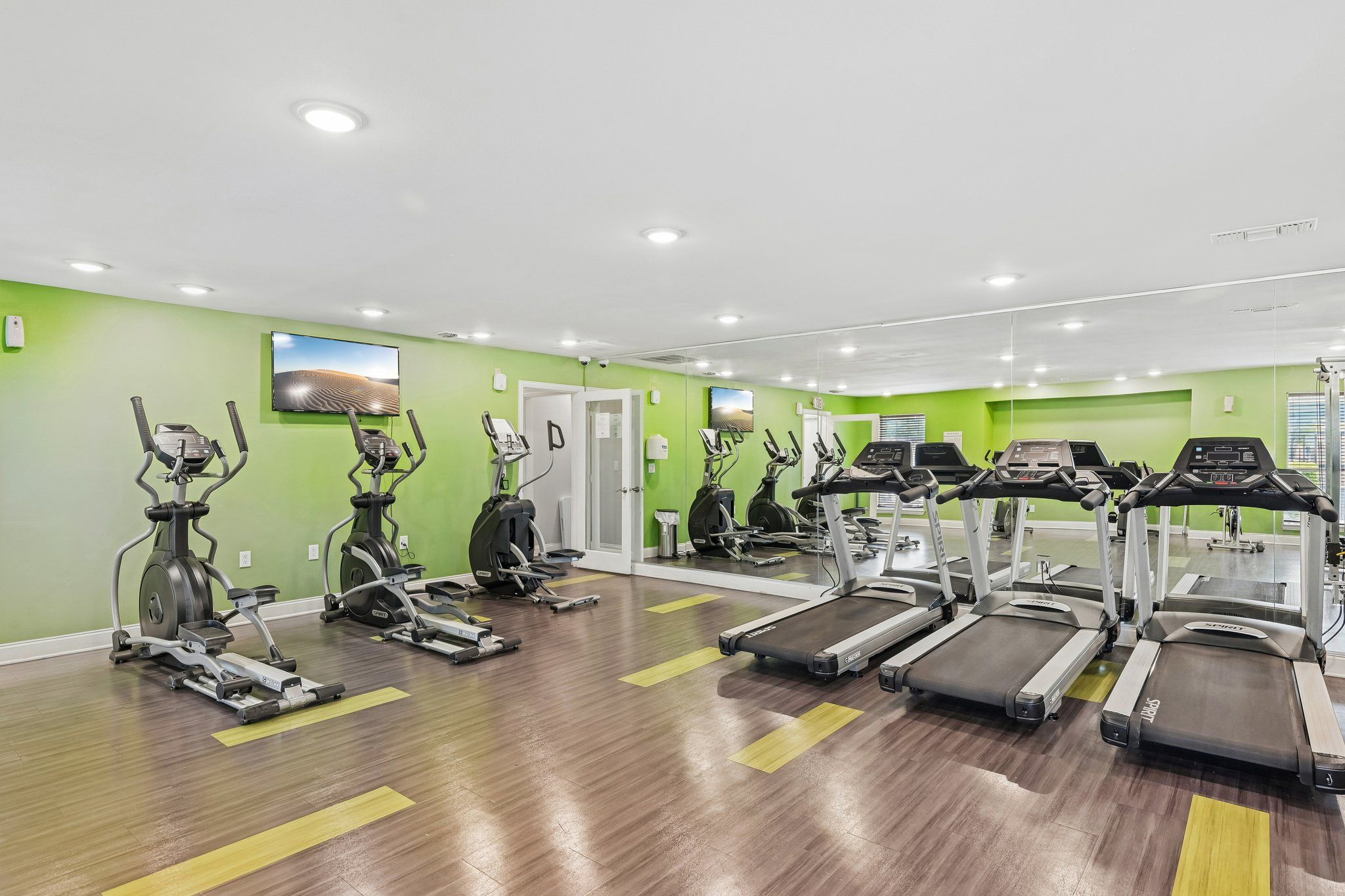 A gym with treadmills and exercise bikes.